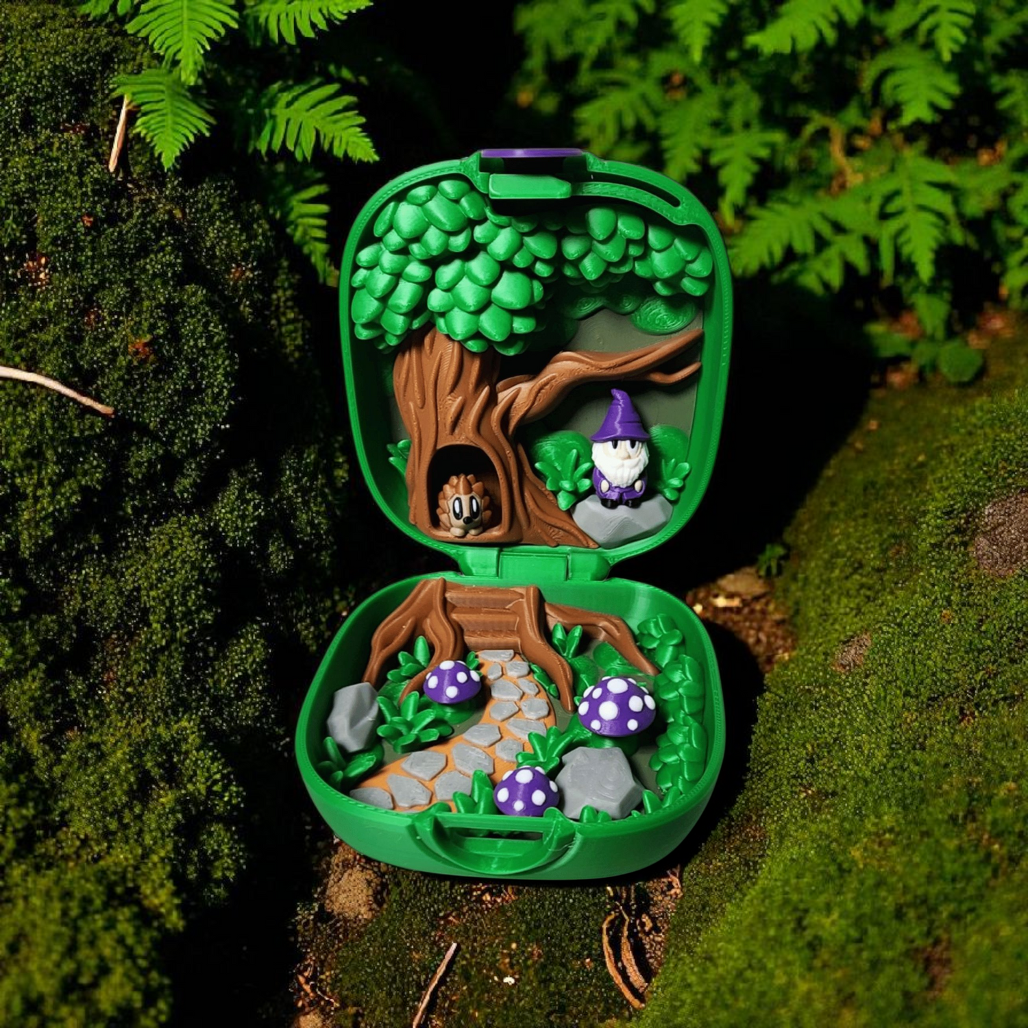 small green case that opens and has a scenery inside with mushrooms, a wizard and a hedgehog