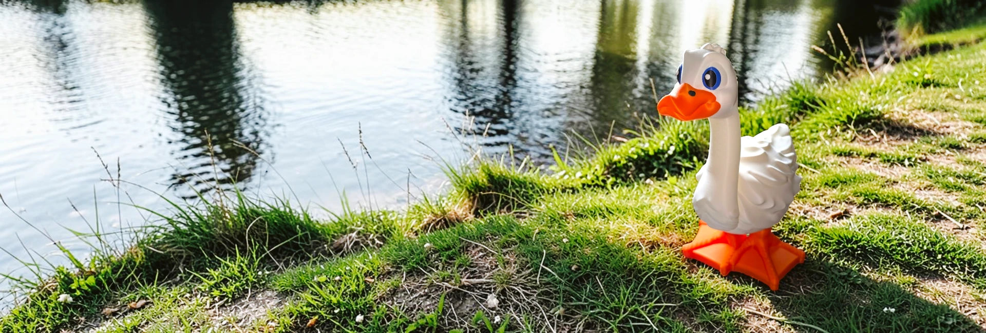  Toy goose on grass near a body of water