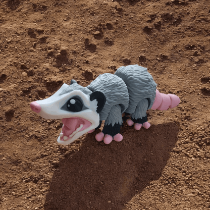 opossum outside on a dirt surface