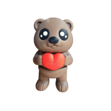 Adorable brown teddy bear holding a red heart