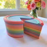 Fragrant Moon Designs rainbow layered pretend cake with a slice removed, perfect for play kitchens.